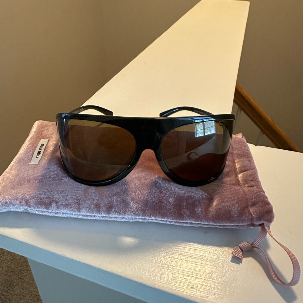 Miu Miu Elegant Black Sunglasses with Gold Accents